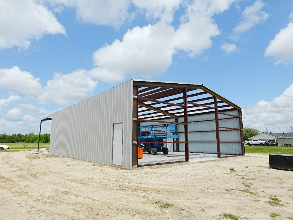 Red iron steel building frame going up on a job site